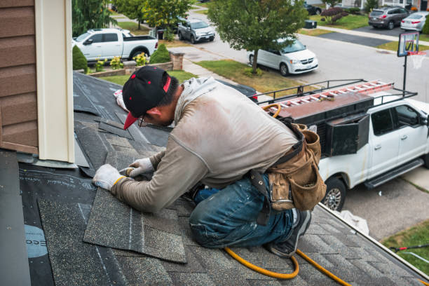 Professional Roofing technician working in East Marion, NY